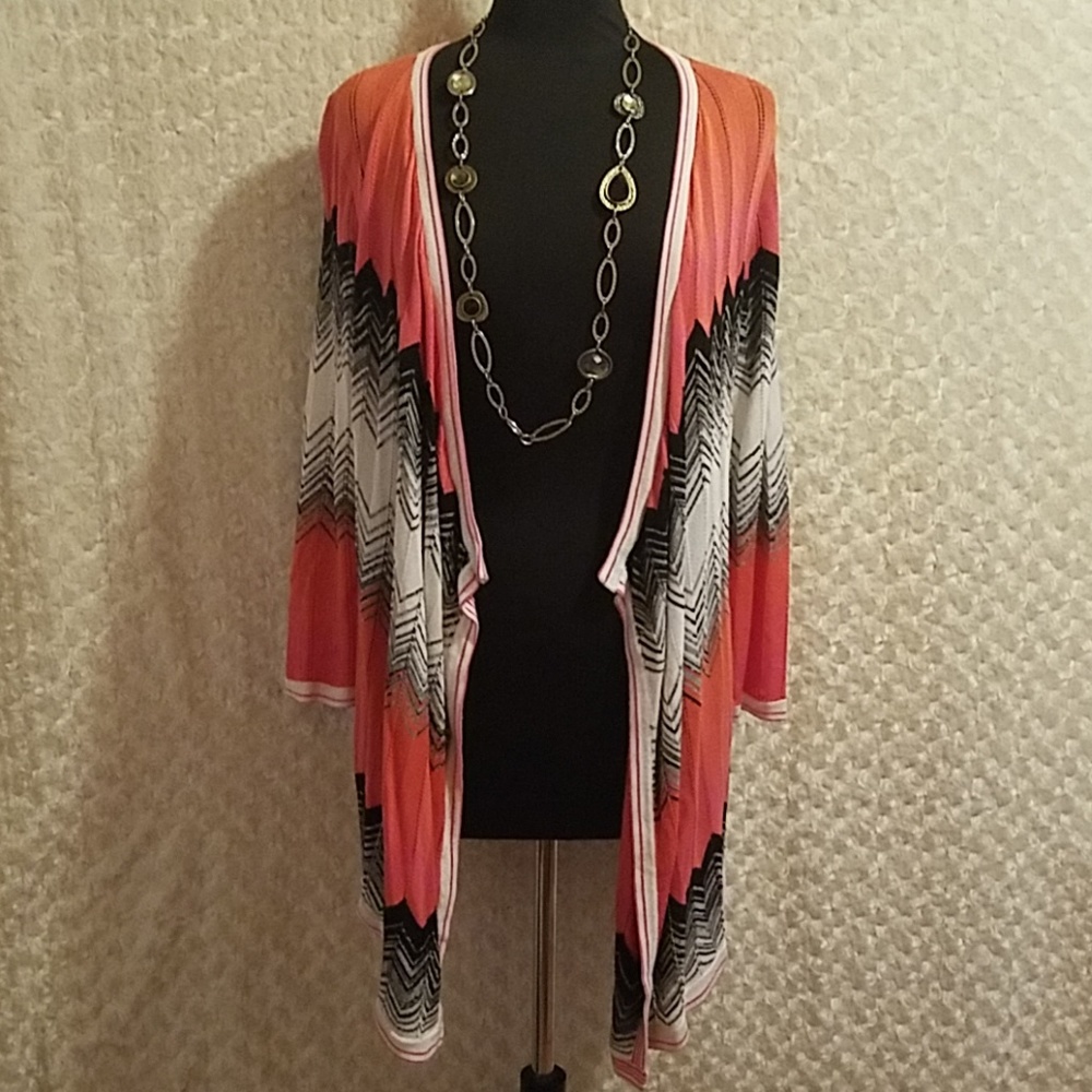 Red brand rusty pink, black, and white sweater